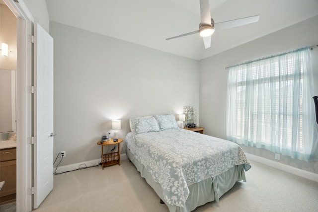 bedroom featuring baseboards, a ceiling fan, and light colored carpet