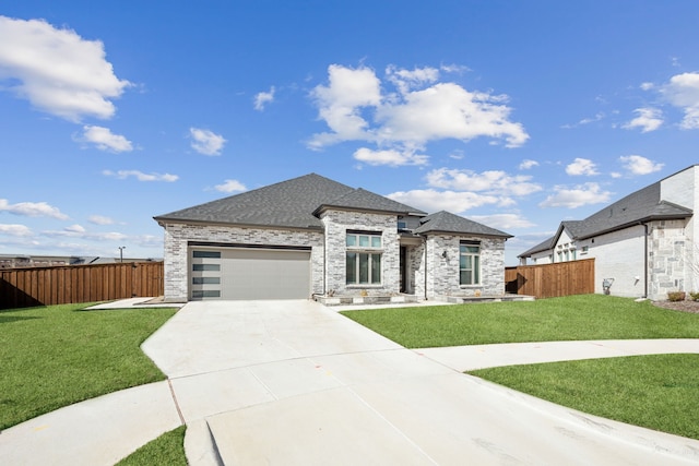 view of front of home featuring a garage, fence, concrete driveway, and a front yard