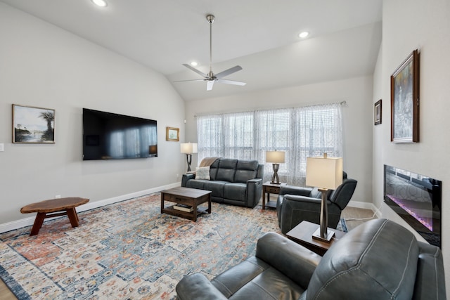 living room featuring lofted ceiling, recessed lighting, a ceiling fan, a glass covered fireplace, and baseboards