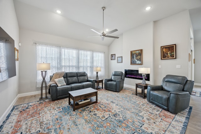 living area featuring lofted ceiling, ceiling fan, baseboards, and recessed lighting