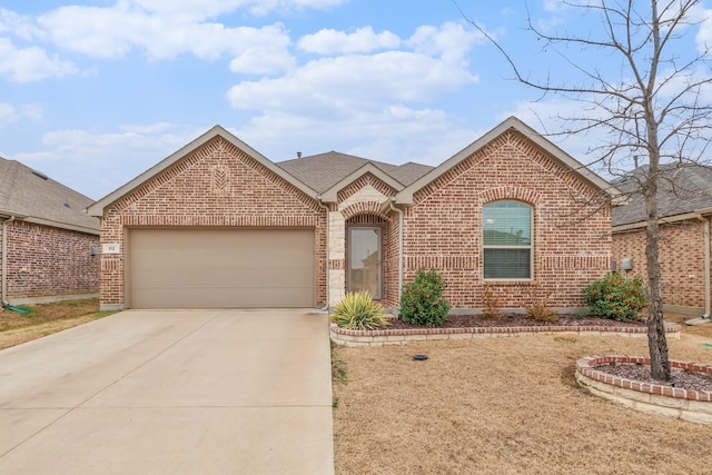 view of front of house with an attached garage, driveway, a shingled roof, and brick siding