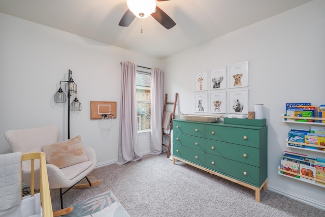 interior space featuring carpet, baseboards, and ceiling fan