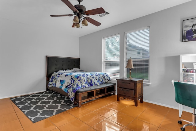 tiled bedroom with baseboards, visible vents, and ceiling fan