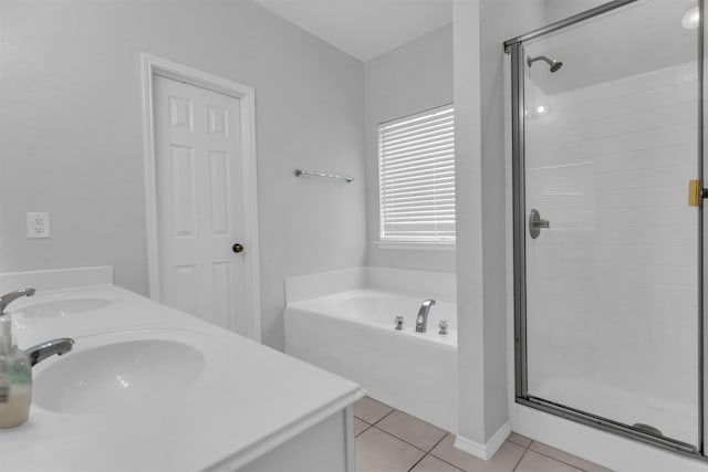 full bathroom featuring a garden tub, a sink, a shower stall, and tile patterned floors