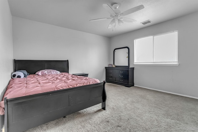 bedroom featuring ceiling fan, carpet floors, visible vents, and baseboards