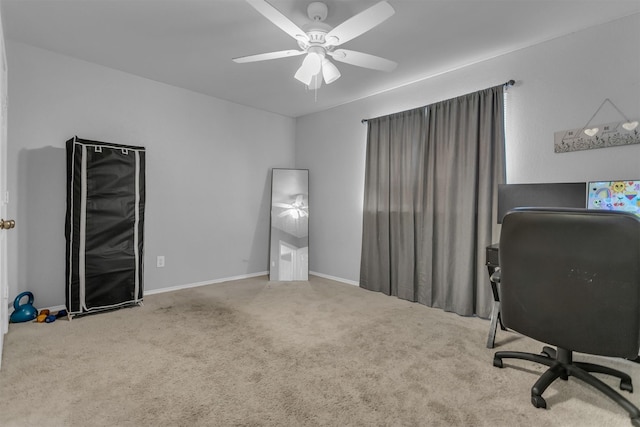 office area with carpet flooring, a ceiling fan, and baseboards