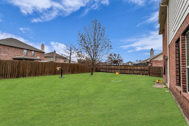 view of yard with a fenced backyard