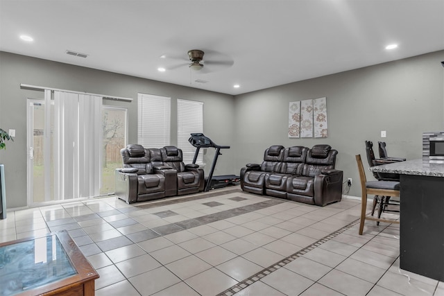 living room with light tile patterned floors, a ceiling fan, visible vents, and recessed lighting