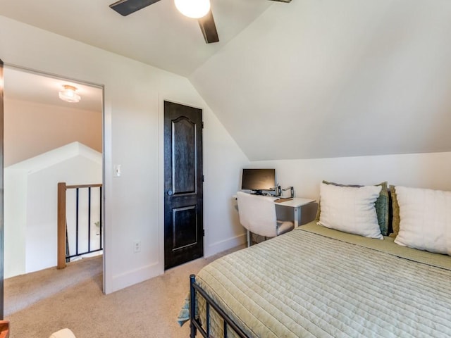 bedroom featuring light carpet, vaulted ceiling, a ceiling fan, and baseboards