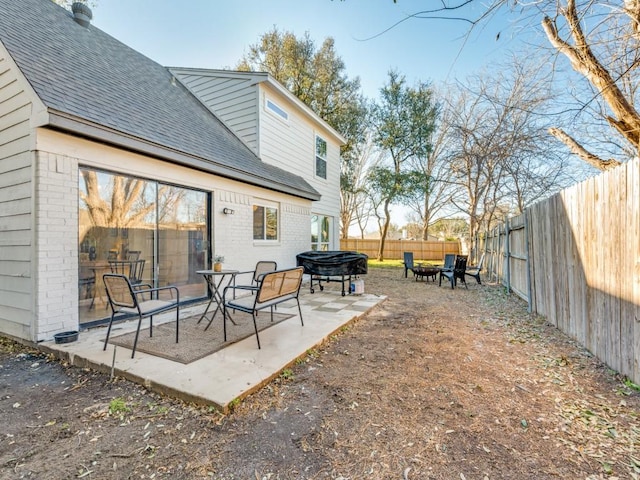 exterior space with a patio area, an outdoor fire pit, and a fenced backyard