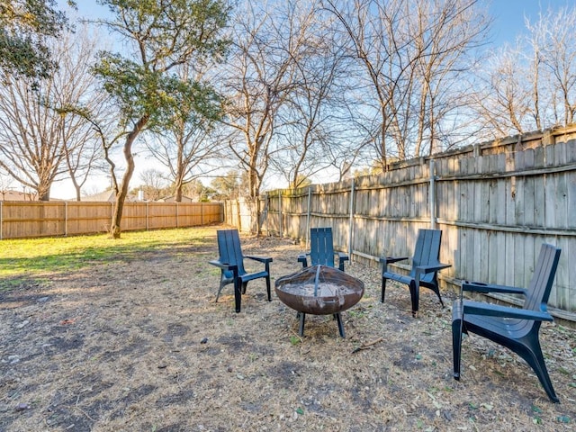 view of yard with an outdoor fire pit and a fenced backyard