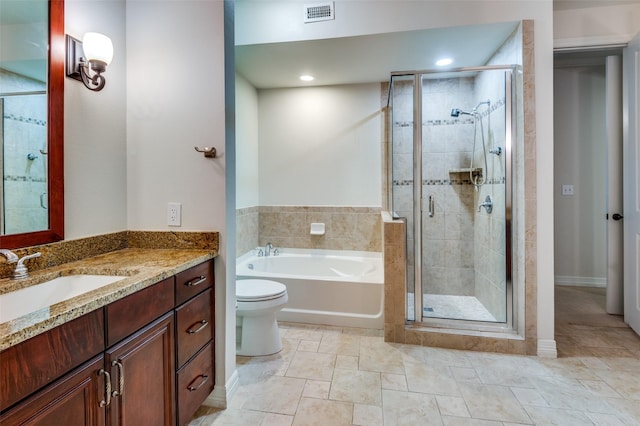 bathroom featuring visible vents, vanity, a garden tub, and a shower stall