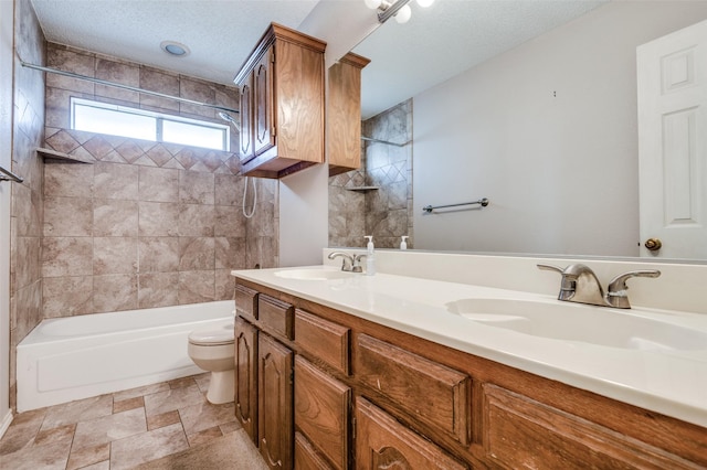 bathroom featuring shower / tub combination, a sink, a textured ceiling, and toilet