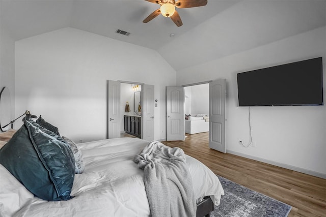 bedroom with visible vents, vaulted ceiling, baseboards, and wood finished floors