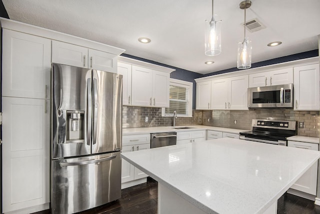 kitchen with white cabinetry, visible vents, appliances with stainless steel finishes, and a sink