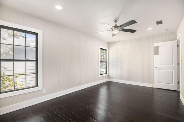 empty room with ceiling fan, dark wood-type flooring, recessed lighting, and baseboards