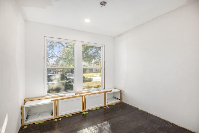 spare room featuring dark wood finished floors