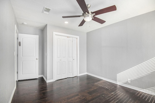 unfurnished bedroom with baseboards, a closet, visible vents, and hardwood / wood-style floors