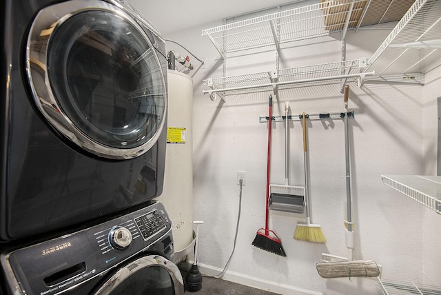 laundry area with stacked washer and dryer, baseboards, and laundry area