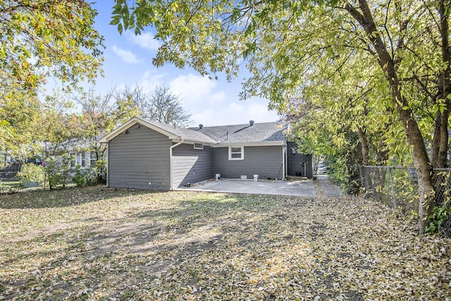 rear view of property with a patio and fence