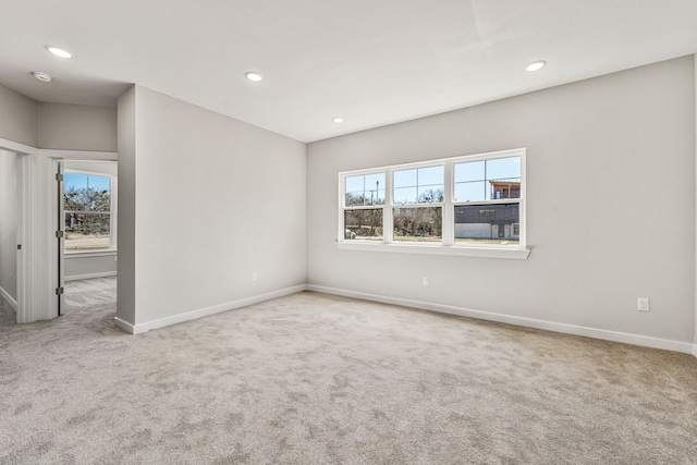 carpeted spare room featuring recessed lighting and baseboards