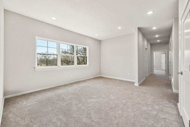 empty room with recessed lighting, baseboards, and light colored carpet