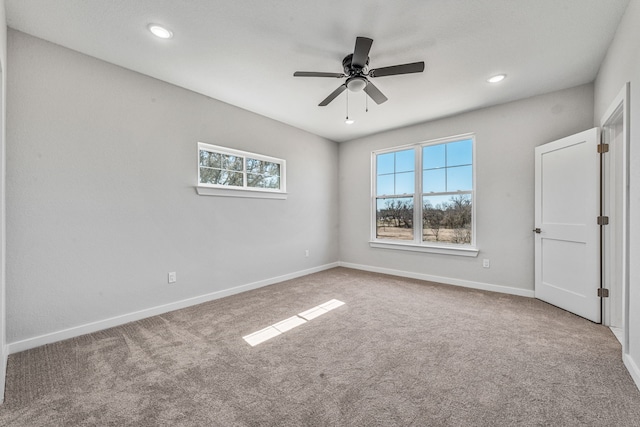 spare room featuring baseboards, carpet, and a healthy amount of sunlight