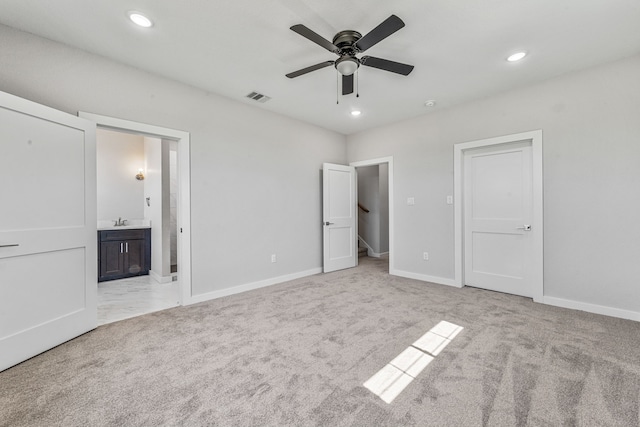 unfurnished bedroom with light carpet, visible vents, and recessed lighting