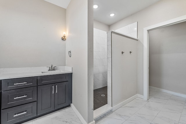 full bath featuring marble finish floor, walk in shower, vanity, and baseboards