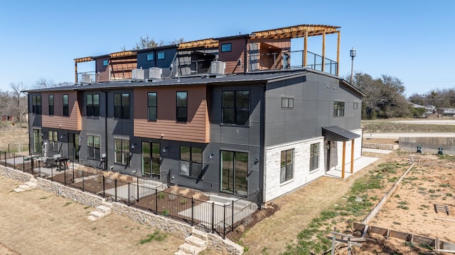 exterior space with a balcony, fence, and a patio