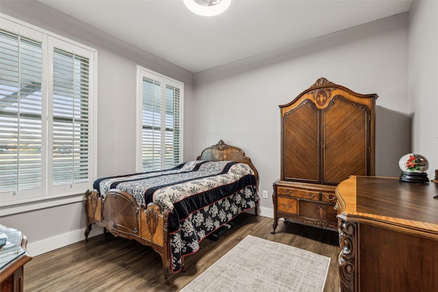 bedroom featuring baseboards and wood finished floors