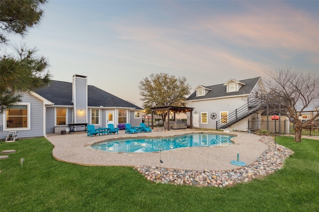 view of pool featuring a patio, a yard, fence, and a fenced in pool