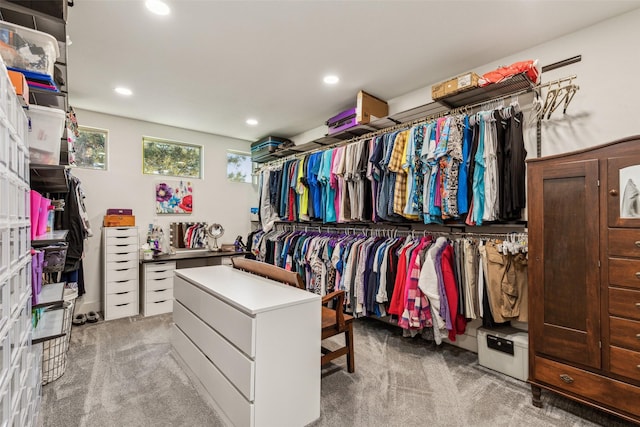 walk in closet featuring light colored carpet