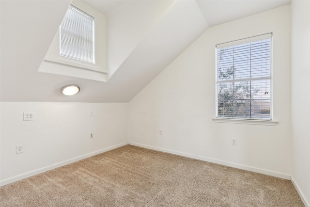 bonus room featuring lofted ceiling, carpet, visible vents, and baseboards