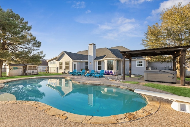 view of swimming pool featuring a hot tub, fence, a fenced in pool, and a patio