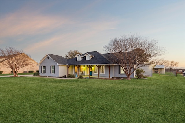 view of front of house with a porch and a yard