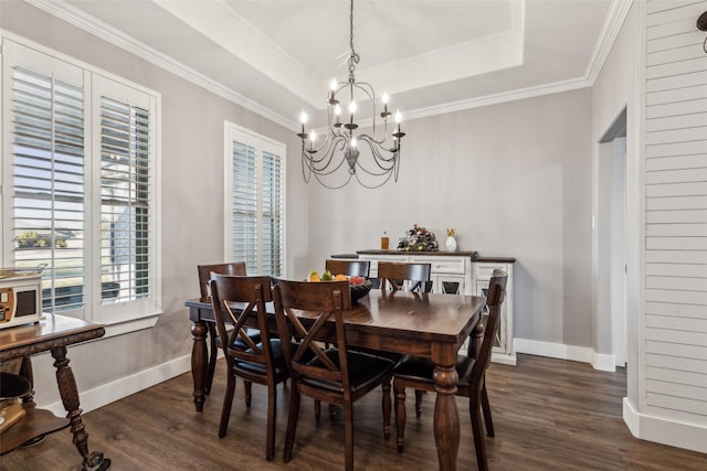 dining room featuring baseboards, a tray ceiling, dark wood finished floors, and an inviting chandelier