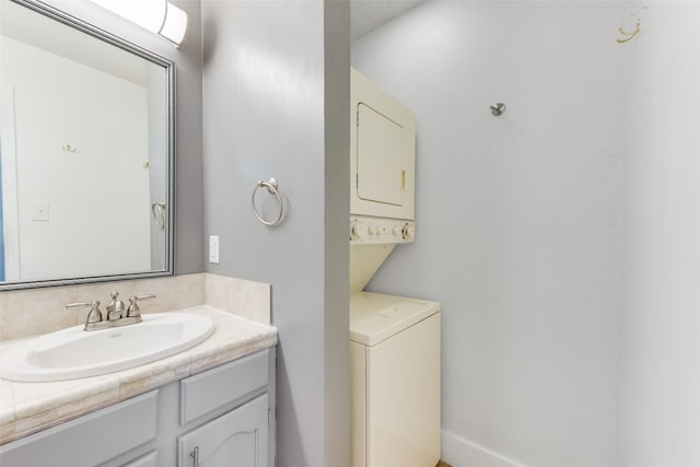 bathroom with stacked washer / dryer and vanity