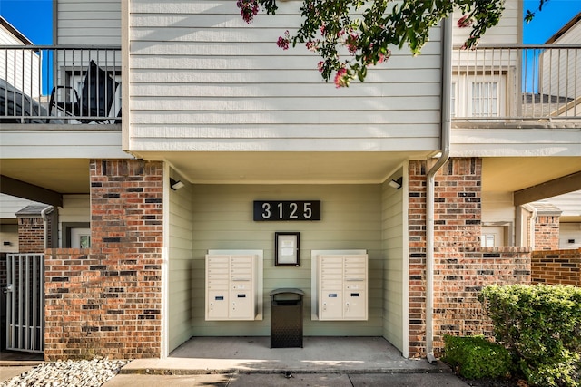 entrance to property featuring brick siding