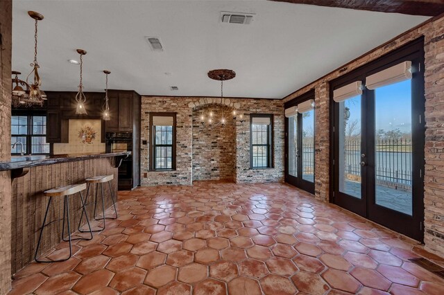 541 Hidden Lakes Blvd, Gunter, TX 75058 - kitchen featuring a breakfast bar area, visible vents, dark countertops, and a chandelier