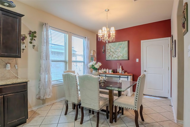 dining space featuring a wealth of natural light, a notable chandelier, and light tile patterned floors