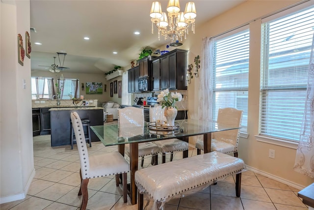 dining area with light tile patterned floors, ceiling fan with notable chandelier, baseboards, and recessed lighting