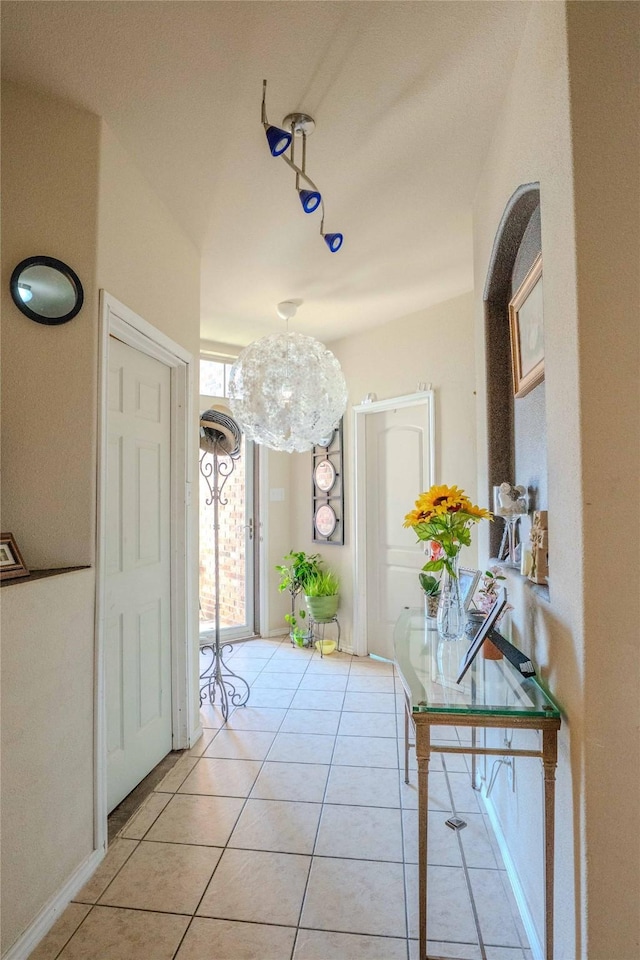 entrance foyer featuring light tile patterned floors and baseboards