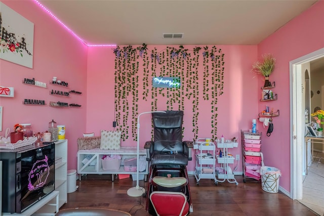 game room with baseboards, wine cooler, visible vents, and wood finished floors