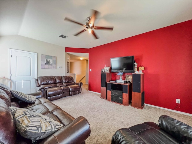 living area featuring a ceiling fan, visible vents, vaulted ceiling, and carpet flooring