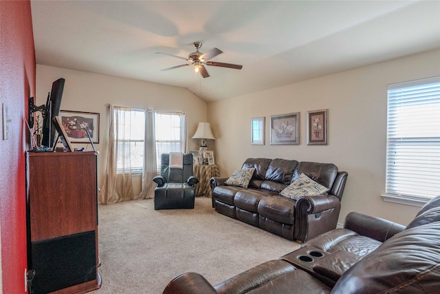 carpeted living room with a ceiling fan and vaulted ceiling