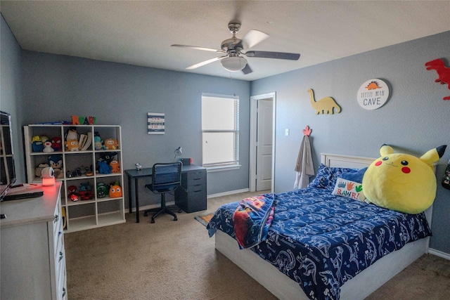 carpeted bedroom featuring a ceiling fan and baseboards