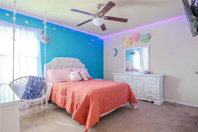 carpeted bedroom with a ceiling fan and baseboards