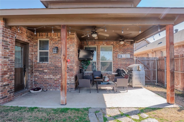 view of patio featuring fence, an outdoor living space, a ceiling fan, and area for grilling