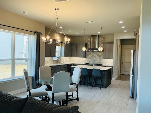 dining area featuring baseboards, visible vents, a chandelier, and recessed lighting